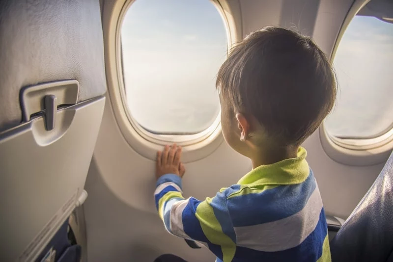 Child on a plane, looking out of the window