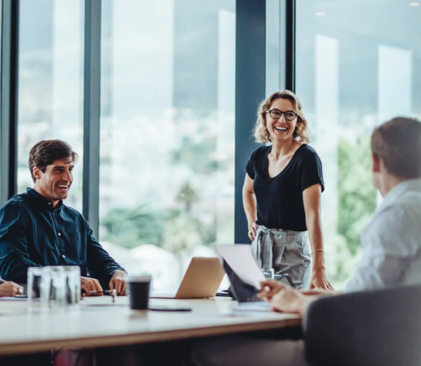 group of colleagues sat smiling at a table