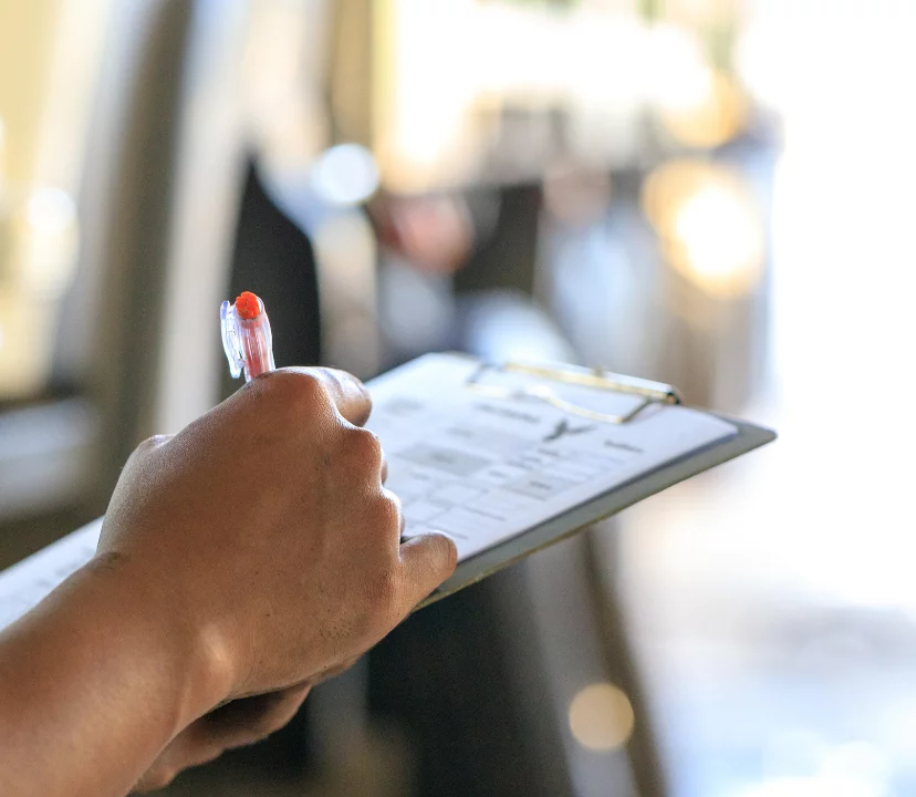 women writing on a clipboard