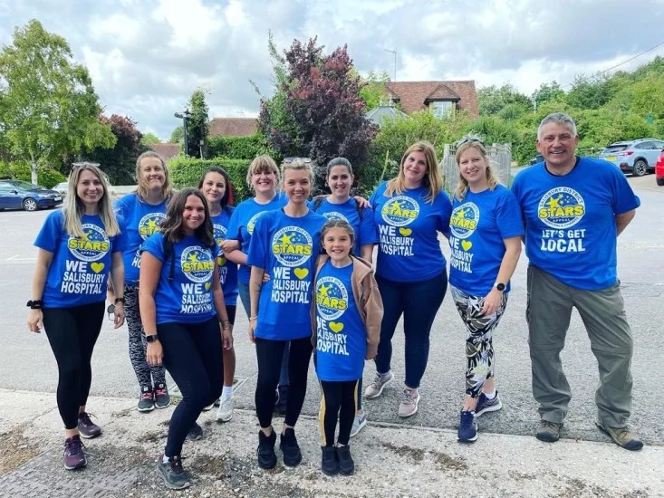 Trethowans staff with Let's get local t shirts to celebrate raising nearly £2,000 for Salisbury District Hospital