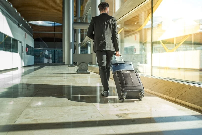 Man in suit walking across the airport