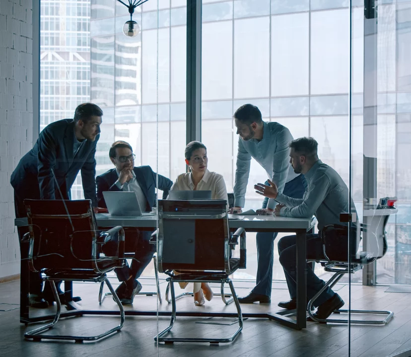 group of colleagues sat around table, sharing ideas