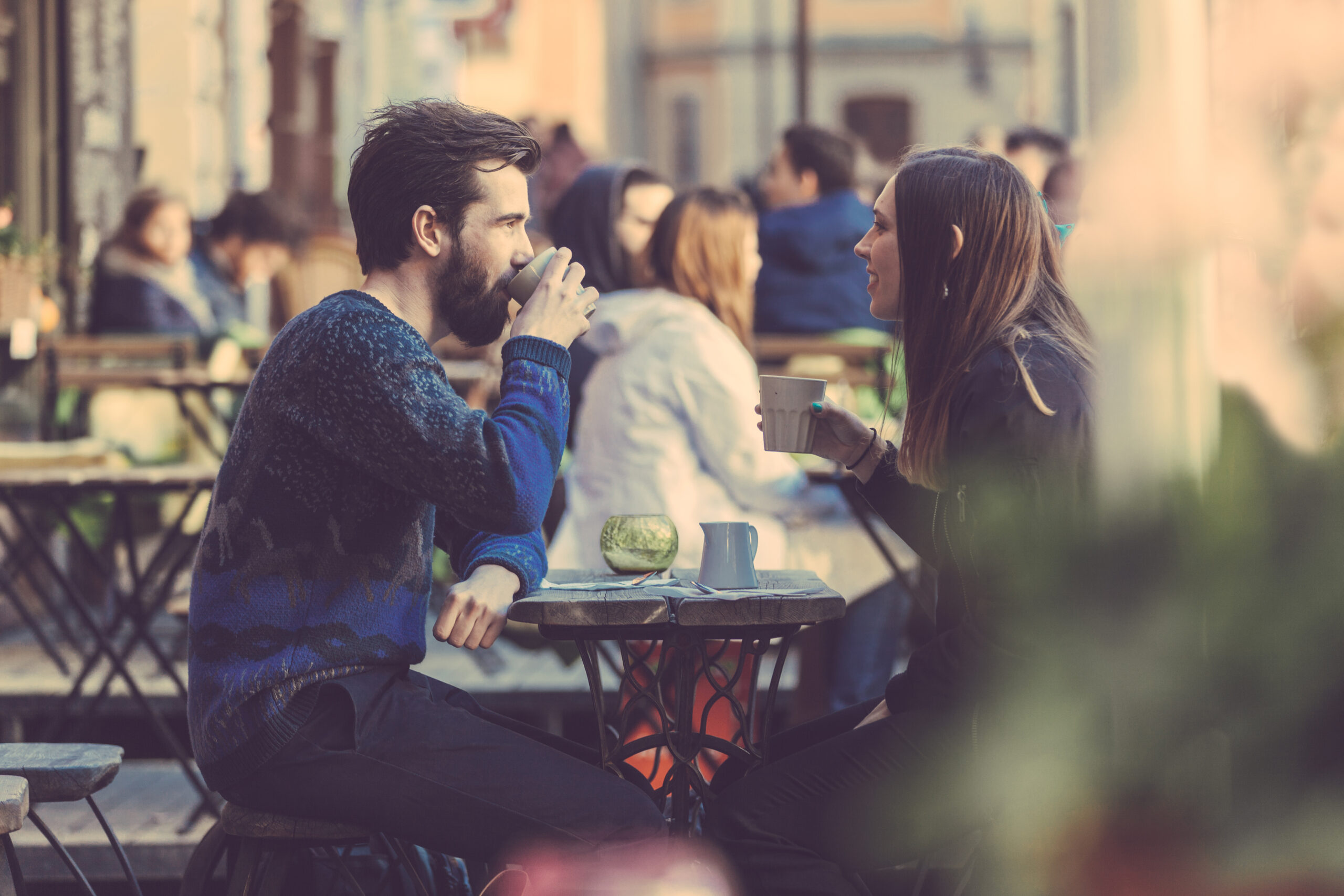 Couple drinking coffee in outside safe smiling