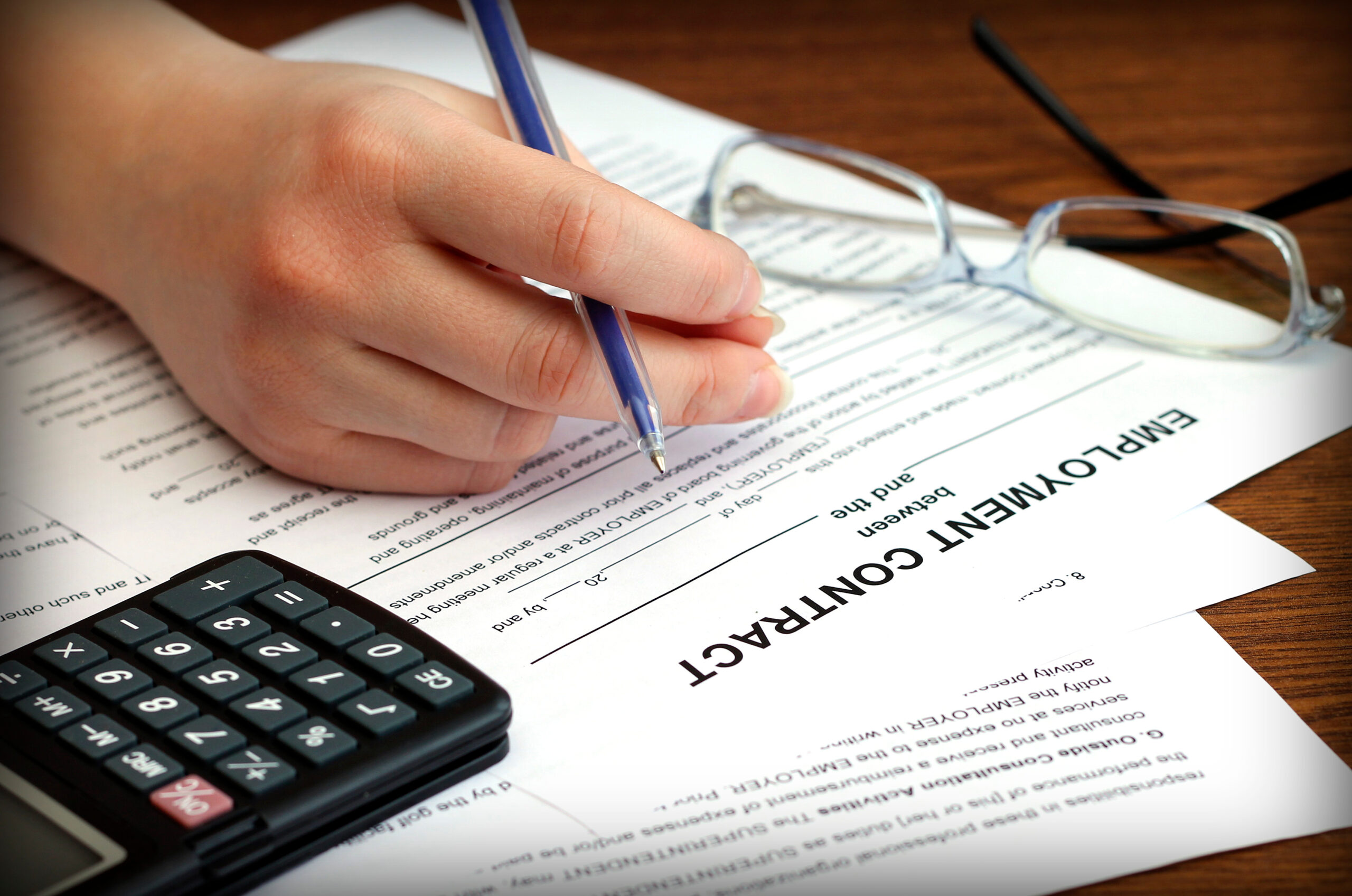 Employment contract with women reading over with pen