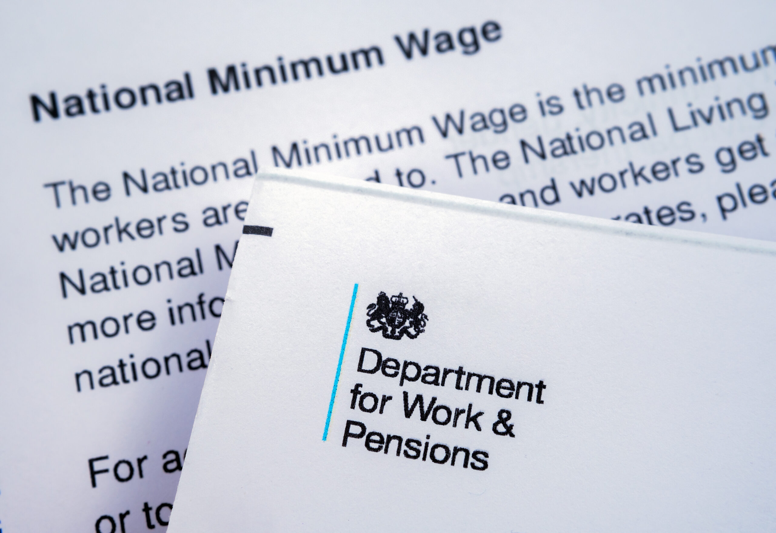 letter from UK Department for work and Pensions placed on top of letter about National insurance number and Minimum wage.
