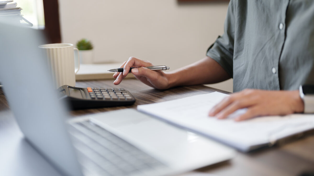 Female calculating personal financial for future plan at her home, taxes payment.