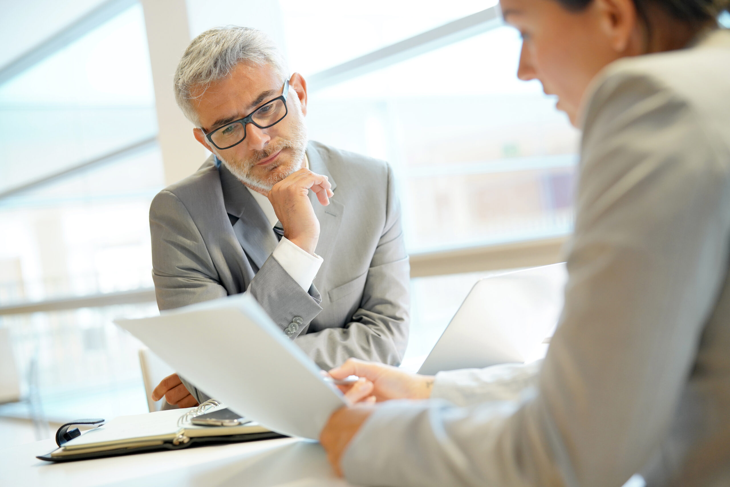Man and women looking over document in meeting