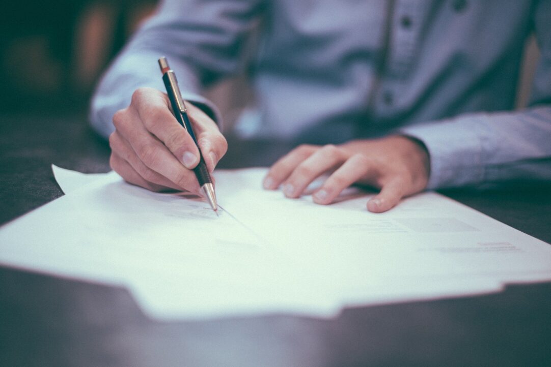 man writing contract