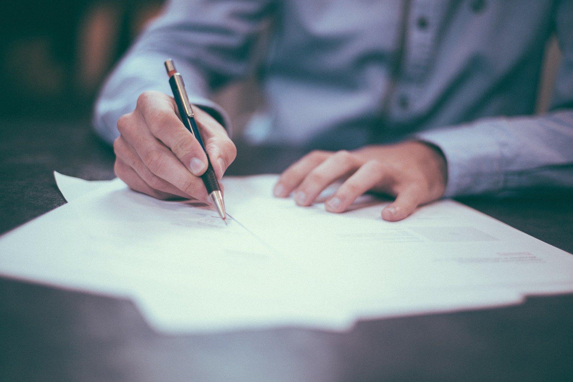 man writing contract