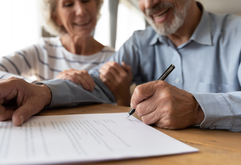 Old couple signing a will document