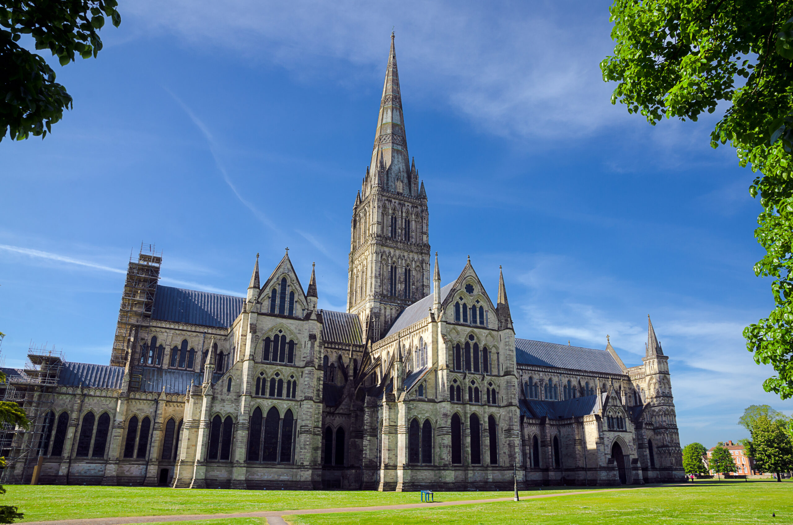 a wide photo of salisbury cathedral on a blue sky day